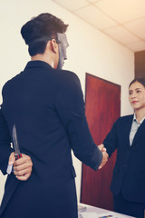 Businessmen wear masks, discuss business ideas, business people have a mask, have a secret knife.