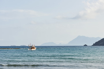 Boats float in the calm blue sea water in Turkey