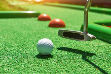 Golf ball and Golf Club on Artificial Grass