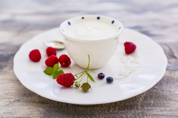 A bowl of healthy and delicious yogurt and fresh raspberry fruits. 