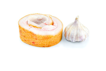 Pork belly and not peeled garlic isolited on a white background.