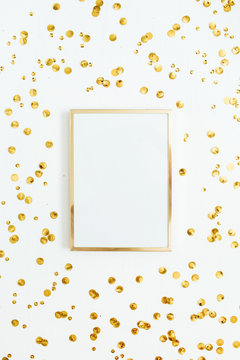 Photo frame mock up with space for text and golden confetti on white background. Flat lay, top view. Minimal background.