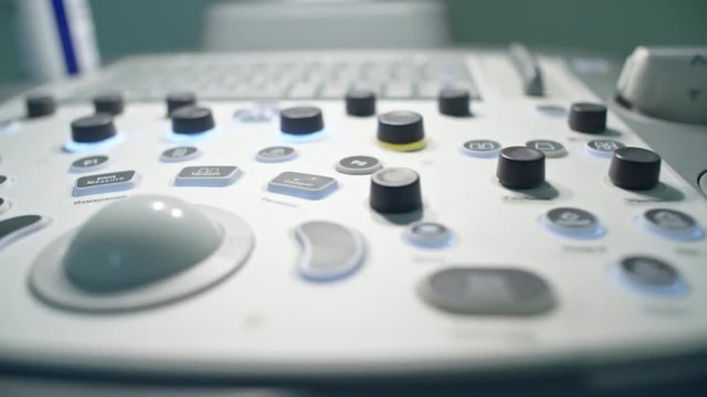 PAN with close up of control panel of medical ultrasound machine