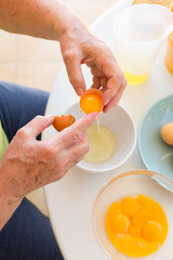 broken eggs. women's hands break eggs