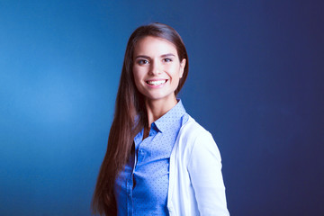 Portrait of a businesswoman , against dark background. Woman smiling. Portrait of a woman