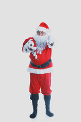 Real Santa Claus carrying big bag full of gifts, isolated on white background