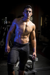 Fototapeta na wymiar Young muscular man in gym