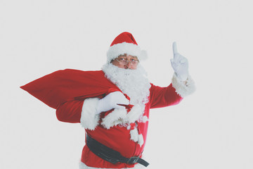Real Santa Claus carrying big bag full of gifts, isolated on white background