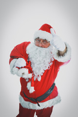 Real Santa Claus carrying big bag full of gifts, isolated on white background
