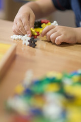 Toddler having fun and building out of constructor bricks