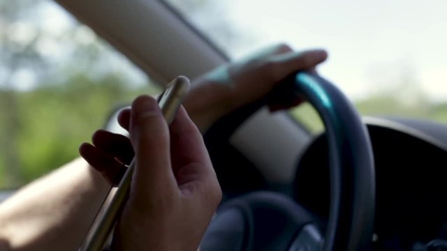 Slow Motion Closeup Of Man Driving, He Receives A Phone Call, Brings The Phone To His Ear 