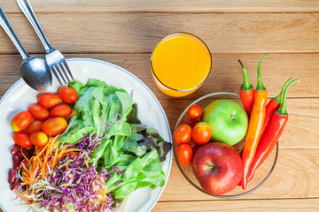 Healthy concept with mixed fruits and vegetables on wooden background