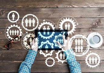 Concept of teamworking and connection with gears mechanism and tablet pc