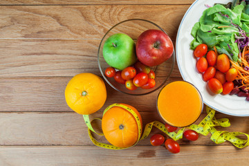 Healthy concept with mixed fruits and vegetables on wooden background