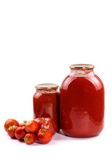 Banks with tomato juice and tomatoes on a white background
