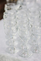 Row of glass on catering event on table.