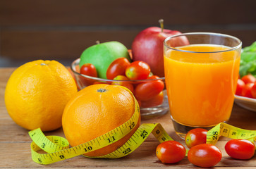 Healthy concept with mixed fruits and vegetables on wooden background