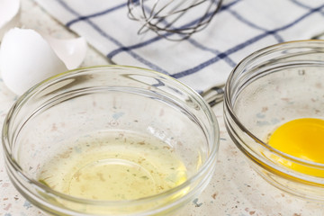 The yolk and the white separated in glass bowl