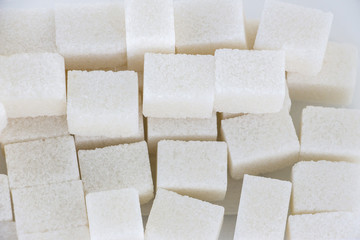 White sugar lumps. View from above. Abstract background