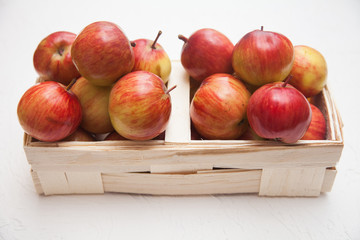 Apples in a wooden box. White background.