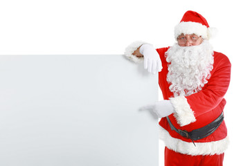 Happy Santa Claus looking out from behind the blank sign isolated on white background