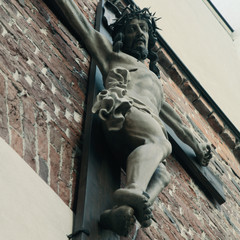 Holy cross with crucified Jesus Christ (close up of ancient statue)