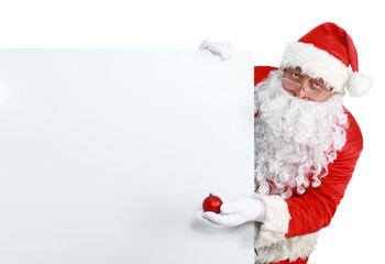 Happy Santa Claus looking out from behind the blank sign isolated on white background