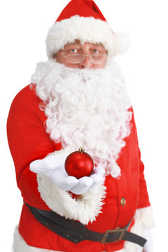 Real Santa Claus holding christmas ball, isolated on white background