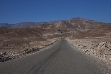 Fototapeta na wymiar Road through the Atacama Desert from Arica on the coast to the small town of Putre on the Altiplano of northern Chile.