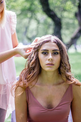 Hairdresser creating beautiful style for young lady.