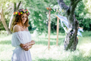 Fototapeta na wymiar Wedding background. Bride in wedding dress with flower wreath on hairs.