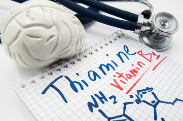 Vitamin B1 Thiamin concept photo. Stethoscope and brain figure lies next to inscription Vitamin B1...
