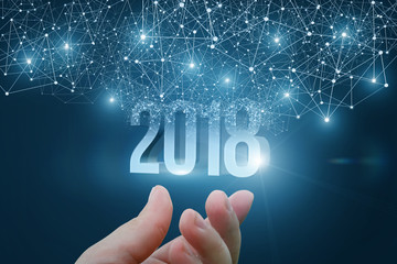 Hand holding the 2018.