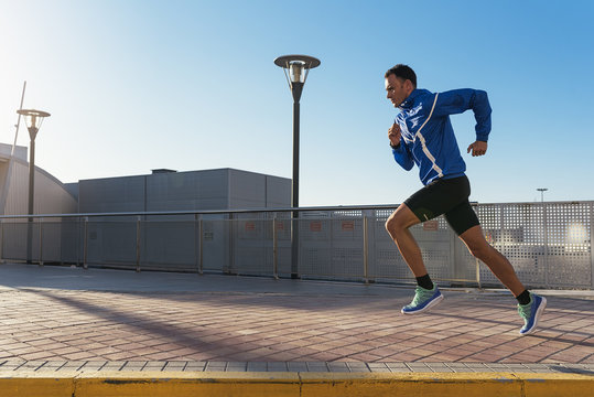 Handsome man running in the city.