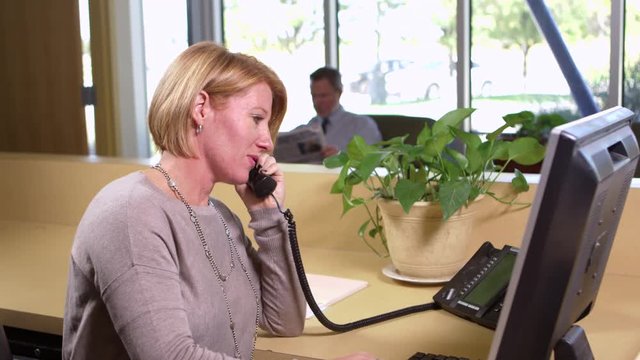 Receptionist takes a phone call