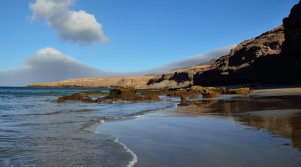 Stunning sandy beach and rocks, Las coloradas, coast of Fuerteventura, Canary islands
