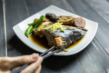 Steamed salmon head with soy sauce with vegetables., Salmon kabutoni, Close up Salmon