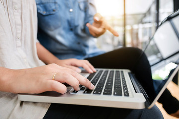 two women friendship working at library and  use laptop