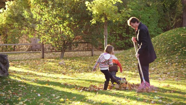 Family raking in autumn