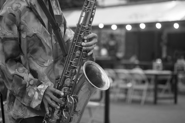 Obraz premium man live music on street with playing trumpet, musical instruments with monochrome black and white tone.