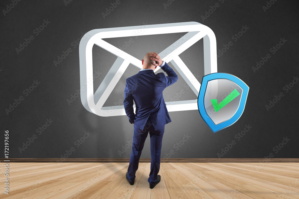 Poster businessman in front of a wall with approved and verified email symbol displayed on a futuristic int