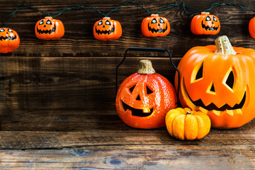 Halloween pumpkin heads on wooden background