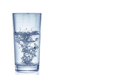 Glass filled with mineral water on white background