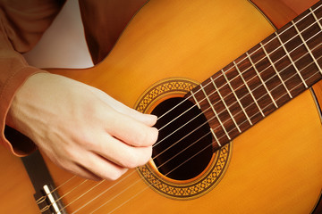 Fototapeta premium Classical guitar hands strings. Acoustic guitar player