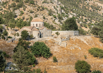 Abandoned old orthodox Christian church and olive tree