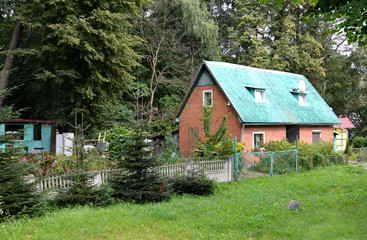 Brick lodge on the seasonal dacha about the wood