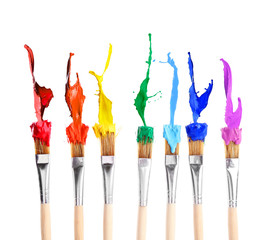 Brushes with colorful paints, isolated on white