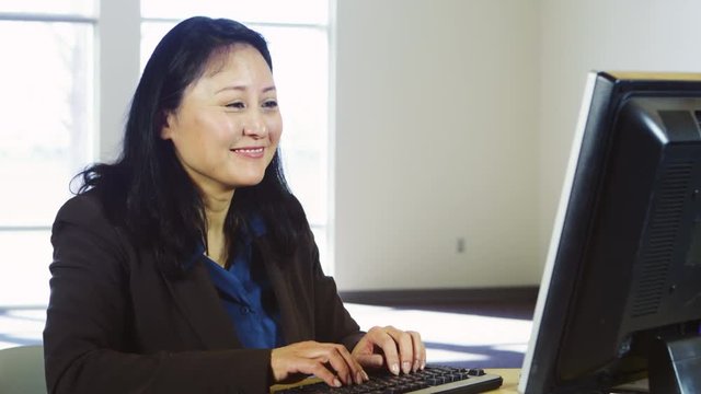Portrait of woman using computer and typing
