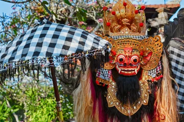 Fotobehang Rangda Mask under red umbrella in temple - traditional spirit of Bali at ceremony Melasti before Balinese New Year and silence day Nyepi Holidays, festivals, rituals, art, culture of Indonesian people © Tropical studio