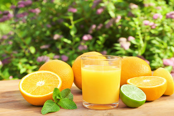 Glass of fresh orange juice on table